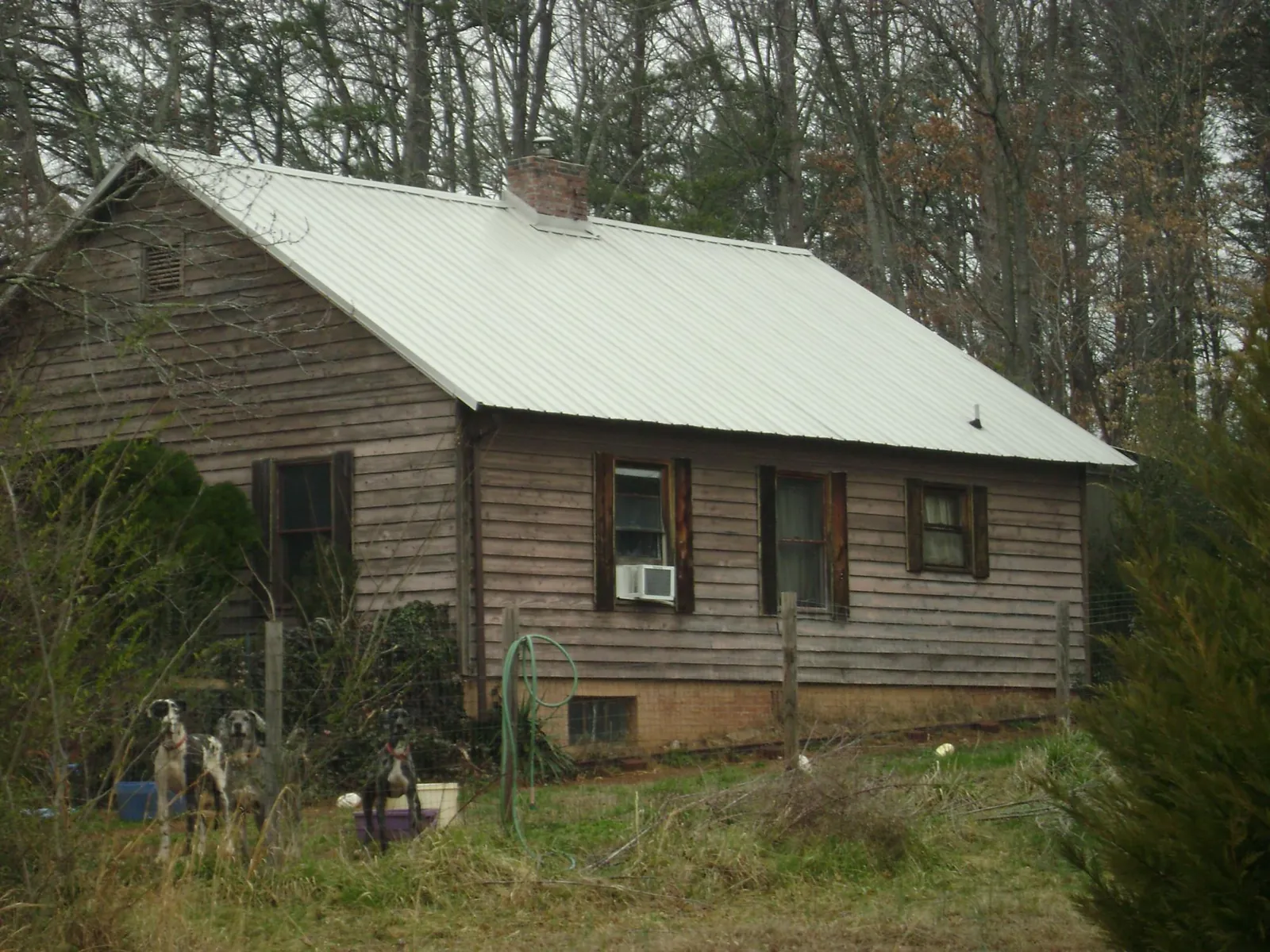 White metal roof on an old wood sided farmhouse, from a Metal Roof Installation job in Outlook